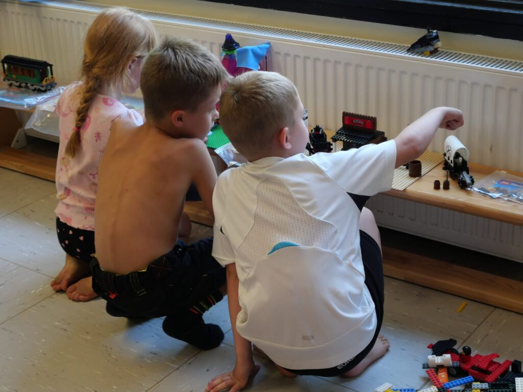 Drei Kinder begutachten die gebauten Teile der Westernstadt